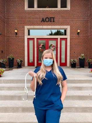 Jaci Deitrick stands in front of her sorority house at Oklahoma State University. As a student enrolled in both the Meridian Technology Center Health Careers program and OSU, Deitrick has balanced classes on both campuses this year.