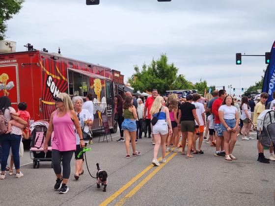 Streets lined with food trucks, booths and people